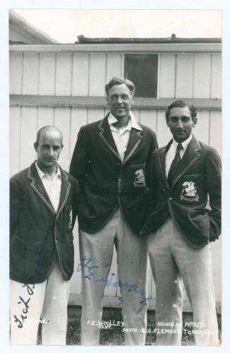 Kent C.C.C. c.1932. Mono real photograph postcard of Tich Freeman and Frank Woolley standing three quarter length with the Nawab of Pataudi in M.C.C. tour blazers. Signed to the photograph by Freeman and Woolley. Flemons of Tonbridge. Postally unused. Ver