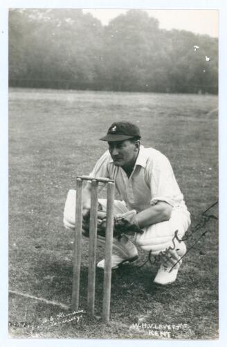 William Howard Vincent ‘Hopper’ Levett. Original mono real photograph postcard of Levett crouched in wicket-keeping pose wearing Kent cap. Nicely signed in ink to the image by Levett. B.C. Flemons of Tonbridge. Postally unused. Small adhesive marks to ver