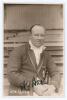 Arthur William Carr. Nottinghamshire & England 1910-1934. Early sepia real photograph postcard of Carr seated half length on pavilion steps, wearing cricket attire and M.C.C. touring blazer. C.H. Richards of Nottingham. Very nicely signed in black ink to 