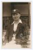 Samuel James &lsquo;Sam&rsquo; Staples. Nottinghamshire & England 1920-1934. Early sepia real photograph postcard of Staples seated half length on pavilion steps, wearing Nottinghamshire cap and blazer. C.H. Richards of Nottingham. Very nicely signed in ink to the ph