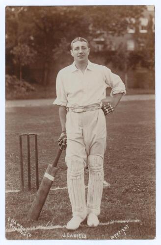 John Daniell. Somerset & Cambridge University 1898-1927. Early sepia real photograph postcard of Daniell (incorrectly titled &lsquo;J. Daniels&rsquo;) standing full length at the crease wearing batting attire and leaning on his bat. E. Hawkins & Co., Brighton. Postal