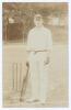 John Neville &lsquo;Jack&rsquo; Crawford. Surrey, South Australia & England 1904-1921. Early sepia real photograph postcard of Crawford standing full length at the wicket wearing cricket attire and Surrey cap, leaning on his bat. Foster of Brighton. Postally unused. 