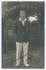 Andrew &lsquo;Andy&rsquo; Ducat. Surrey & England 1906-1931. Early mono real photograph postcard of Ducat standing full length wearing cricket attire and Surrey blazer. Very nicely signed in ink to the photograph by Ducat. Blind embossed stamp to lower left corner fo
