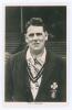 Edward William John &lsquo;Ted&rsquo; Brooks. Surrey 1925-1939. Original mono real photograph postcard of Brooks, later in his playing career, half length, wearing Surrey blazer. Signed in black ink to the image by Brooks. F.C. Dick, Oval Bookstall. Postally unused. 