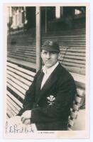 Laurence Barnard ‘Laurie’ Fishlock. Surrey & England 1931-1952. Original mono real photograph postcard of Fishlock seated half length in front of the pavilion at The Oval, wearing Surrey cap and blazer. Signed in blue ink to the lower left corner by Fishl