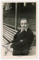 Henry Thomas Barling. Surrey 1927-1948. Mono real photograph postcard of Barling wearing Surrey blazer, seated three quarter length on a bench in the front of the pavilion at The Oval. Very nicely signed to the photograph in black ink by Barling. Printed 