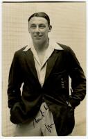 Maurice William Tate. Sussex & England 1912-1937. Mono real photograph postcard of Tate, three quarter length, wearing England blazer in the nets. Signed in black ink by Tate. Postcard by Deane, Wiles & Millar of Brighton. Good condition