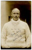 Arthur Edward Robert Gilligan. Cambridge University, Surrey, Sussex & England 1919-1932. Sepia real photograph postcard of Gilligan, standing half length, wearing Sussex sweater. Signed in ink to the image by Gilligan. Postcard by Deane, Wiles & Millar of