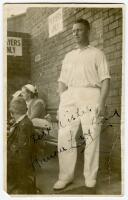 Maurice Leyland. Yorkshire & England 1920-1947. Mono real photograph candid postcard of Leyland standing at the back of the players area at I believe Scarborough, smoking a cigarette. Signed by Leyland in black ink. Some wear to card, some creases and los