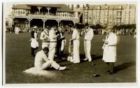 Gentlemen v Players, Scarborough 1931. Sepia real photograph postcard of the tea interval in the match played in September 1931 showing the players being served on the pitch with tea by a waiter and waitress, players stood having a cigarette. George Hirst