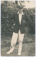 Edward Henry ‘Ted’ Bowley. Sussex, Auckland & England 1912-1934. Original sepia real photograph postcard of Bowley standing full length wearing cricket attire, blazer and Sussex cap. Very nicely signed in black ink to the photograph. Blind embossed stamp 