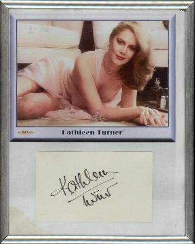 Kathleen Turner. American film actress. Signature of Turner on white card, mounted below colour image of Turner, framed. Crack to glass. Overall 8.25&rdquo;x10.5&rdquo;. G.