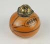 Football inkwell. A Victorian glazed transfer-printed stoneware inkwell, shaped as a slightly deflated football, with plated metal mount and hinged cover formed as a sporting cap, Reg no. 167873 (for 1891) to the underside. Approx 2.75&rdquo; tall. Minor wear, 