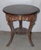 W.G. Grace. Original cast iron circular public house table with circular wooden top, supported by three legs, moulded with portrait busts of Grace wearing cricket cap to top of each leg with imprinted initials &lsquo;W.G&rsquo; above, and decorated pierced apron of b