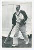 Don Bradman. Mono printed photograph of Don Bradman walking out to the nets, dressed in cricket attire, wearing blazer with pads under arm, carrying gloves and bat. Signed in ink to the photograph in later years by Bradman. 4”x6”. VG - 2