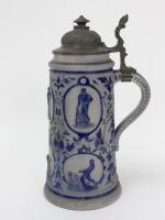 Westerwald stoneware cricket stein, moulded in relief with eight cameo panels of a batsman, fielder and wicket-keeper, six larger and two smaller, all believed to be modelled on W.G. Grace, in different poses, coloured in cobalt blue on a grey background.