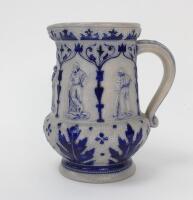 Westerwald stoneware cricket water jug, moulded in relief with five cameo panels of a batsman, believed to be W.G. Grace, in different poses, coloured in cobalt blue on a grey background. The body decorated with vine and sprig decoration with decorated st