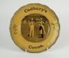 Cricket plate. ‘Cadbury’s Cocoa. The Oldest and still the best. Absolutely Pure Cocoa’. An advertising plate for Cadbury’s printed to centre with a cricket scene of a boy serving a cup of cocoa to a batsman during a game, wicket keep and fielders plus cro