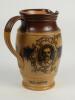 W.G. Grace. Impressive Doulton Lambeth stoneware jug with pale body and dark brown rim, decorated with three portraits/roundels of W.G. Grace, K.S. Ranjitsinhji and George Giffen within scrolling foliage. Two tone brown strap handle. Produced in 1896. App - 3