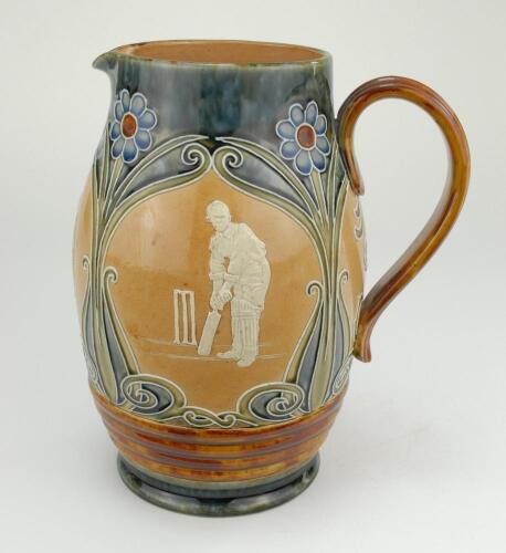 Doulton Lambeth stoneware jug, of ovoid form, moulded with relief vignettes of cricketers, a batsman, bowler and wicket keeper, Abel, Woods and McGregor in white on a brown background. With stylised daisy and floral leaf Art Nouveau decoration to top and