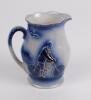 Cricket jug. Victorian Staffordshire blue glazed ceramic jug decorated in relief with a figure of a batsman in front of the wicket, with bushes and a house to background to one side and a gentleman cycling to the other. Floral and bird decoration. The jug - 2