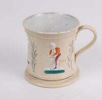 Staffordshire waisted cricket mug with strap handle and beaded rim, with cream background and three raised figures of a batsman, bowler and wicket keeper, believed to be Lillywhite, Pilch and Box decorated in orange, mauve and green. c1870. Silver lustre 