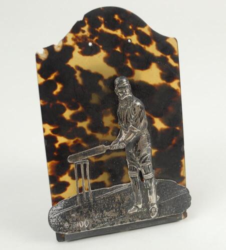 W.G. Grace letter/note holder. A tortoiseshell backing with hinged silver figure of W.G. Grace with bat raised at the wicket. The tortoiseshell backing measures 3”x5” Made by Andrew Barret & Sons of Piccadilly, London and hallmarked London 1895. The back