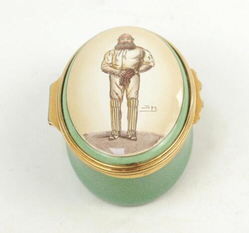 ‘W.G. Grace’. Halcyon Days oval enamelled pill box. The lid decorated with full length figure of Grace by ‘Spy’, biographical details of Grace to the inside of the lid, the inside base with inscription, ‘W.G. Grace, 1848-1915. Hero of English Cricket’. St