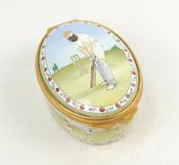 ‘W.G. Grace’. Halcyon Days oval enamelled pill box. The lid decorated with full length figure of Grace in batting pose wearing M.C.C. cap, history of cricket details to the inside of the lid ‘Played in England since the 13th century...’, the inside base w