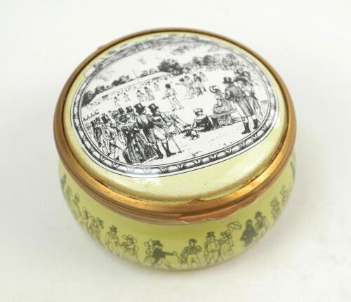 ‘Cricket at Lord’s’. Halcyon Days circular enamelled pill box. The lid with an early cricket scene at Lord’s, the hinged lid revealing title ‘Cricket at Lord’s in the early 19th century’ and small image of a cricketer in top hat. The outer decorated with 