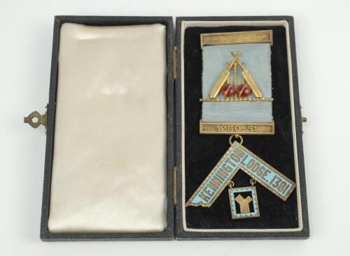 Cricket masonic medal. Original gold metal masonic medal for The ‘Kennington Lodge. 1381’. Pale blue ribbon with gold metal casing to top and bottom with lodge name and masonic emblem beneath. To the centre of the ribbon is an elaborate gold enamel decor