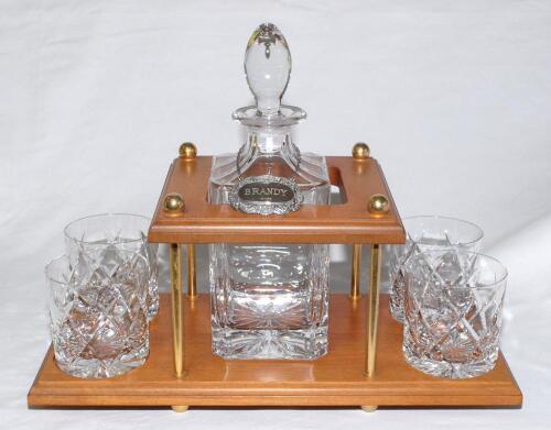 Geoffrey Boycott. Original cut glass decanter and stopper with hallmarked silver brandy label on chain and four tumblers, on wooden stand. Presented to Boycott for his participation in the Dunlop Masters &lsquo;Texas Scramble&rsquo; in 1989. Includes a handwritten no
