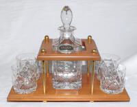 Geoffrey Boycott. Original cut glass decanter and stopper with hallmarked silver brandy label on chain and four tumblers, on wooden stand. Presented to Boycott for his participation in the Dunlop Masters ‘Texas Scramble’ in 1989. Includes a handwritten no