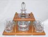 Geoffrey Boycott. Original cut glass decanter and stopper with hallmarked silver brandy label on chain and four tumblers, on wooden stand. Presented to Boycott for his participation in the Dunlop Masters &lsquo;Texas Scramble&rsquo; in 1989. Includes a handwritten no
