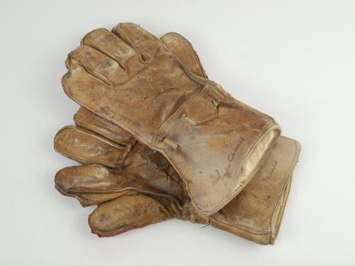 Wicket keeping gauntlets 1920’s. An example of a pair of leather wicket-keeping gloves used in the period, makers unknown but endorsed by Leslie Ames, Kent and England to the back of the glove. These gloves with tan leather backs are ventilated from the b