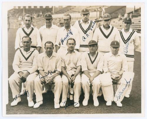 England v All India 1936. Original sepia press photograph of the England team for the drawn second Test match, Old Trafford, 25th- 28th July 1936. The players seated and standing in rows wearing cricket attire, the stands in the background. Very nicely si