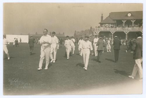 Australia tour of England 1921. Excellent and rare Walkers of Scarborough mono photograph of the Australian team being led onto the field by Captain Warwick Armstrong, the pavilion to background with spectators still wandering around the field. Imprint Wa