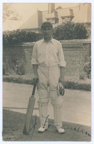 John Robert Freeman. Essex 1905-1928. Early sepia real photograph postcard of Freeman standing full length wearing cricket attire and Essex cap, leaning on a bat. Very nicely signed in ink to the photograph by Freeman. Blind embossed stamp to lower edge f