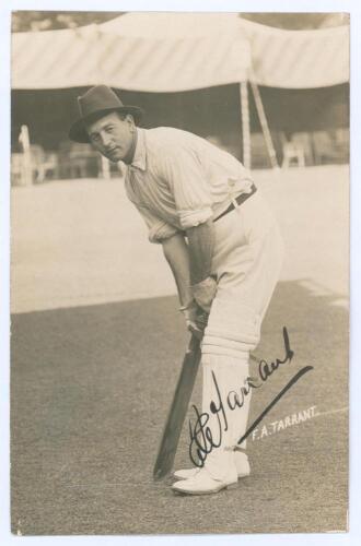 Frank Alfred Tarrant. Victoria, Middlesex, Europeans & Patiala 1898-1937. Rare sepia real photograph postcard of Tarrant depicted standing full length on the outfield in batting pose, wearing an unusual hat, marquees in the background. Very nicely signed 