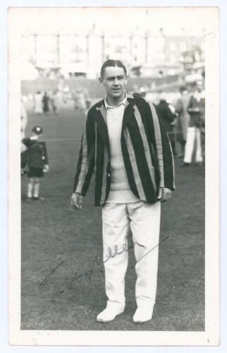 George Oswald Browning ‘Gubby’ Allen. Middlesex, Cambridge University & England 1921-1950. Mono real photograph postcard of Allen standing full length on the outfield at Scarborough, wearing cricket attire and striped blazer. Signed in ink to the photogra