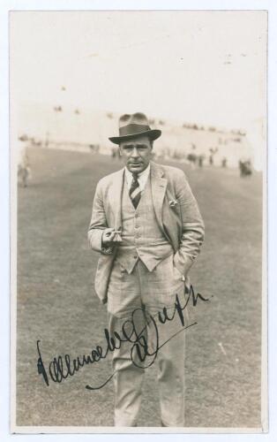 Vallance William Crisp Jupp. Sussex, Northamptonshire & England 1909-1938. Mono real photograph plain back postcard of Jupp, near full length, standing on the outfield at Scarborough, wearing formal attire and trilby hat. Beautifully signed in black ink t