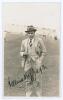 Vallance William Crisp Jupp. Sussex, Northamptonshire & England 1909-1938. Mono real photograph plain back postcard of Jupp, near full length, standing on the outfield at Scarborough, wearing formal attire and trilby hat. Beautifully signed in black ink t