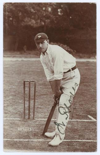 Wilfred Rhodes. Yorkshire, Europeans, Patiala & England 1898-1930. Early sepia real photograph postcard of Rhodes, full length in batting pose at the crease, wearing Yorkshire cap. Nicely signed in black ink to the photograph by Rhodes. Blind embossed sta