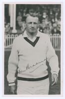 Don Bradman. Mono real photograph plain back postcard of Bradman depicted half length in cricket attire walking on to the field for the match H.D.G. Leveson-Gower&rsquo;s XI v Australians at Scarborough 1948, with facsimile signature. Official stamp to verso fo