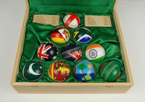 ‘The Flag Ball Collection of the Test playing Nations’. Lord’s. Wooden display folding box containing a set of ten 5.5oz cricket balls all decorated with the individual flag of each Test playing nation to one side and to the other ‘Lord’s. The Home of Cri