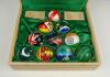 ‘The Flag Ball Collection of the Test playing Nations’. Lord’s. Wooden display folding box containing a set of ten 5.5oz cricket balls all decorated with the individual flag of each Test playing nation to one side and to the other ‘Lord’s. The Home of Cri