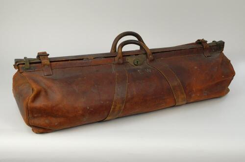 Arthur Edward Wilson. Middlesex & Gloucestershire 1932-1955. Large leather cricket bag used by Wilson during his cricketing career playing for Middlesex and Gloucestershire. The bag has central handles and a central lock strap and buckle, sealed by straps