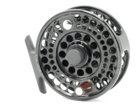A good Charlton 8450c Configurable trout/saltwater fly reel and spare spool, black anodised, left hand wind model, multi-perforated drum with counter-balanced rosewood handle, push button spindle release, block foot and rear star tension adjusting wheel,