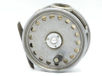 A Hardy St George 3 3/8" trout fly reel, Shallow cored drum with ebonite handle and three screw spring latch, brass foot, neatly tapered at both ends, white agate line guide (no cracks), milled rim tension screw and Mk.II check mechanism, wear from norma