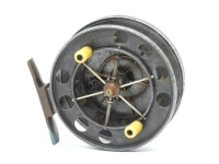 An Allcock Aerial model 7950-T3 4" narrow drummed centre pin reel, caged and six spoked drum with twin ivorine handles, ventilated front flange and twin release/regulator forks, brass stancheon foot, rear sliding optional check button and calliper sprin
